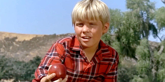 Christopher Shea as Alphie, Smith's son, trying to lure an untamed horse closer with an apple in Smith! (1969)