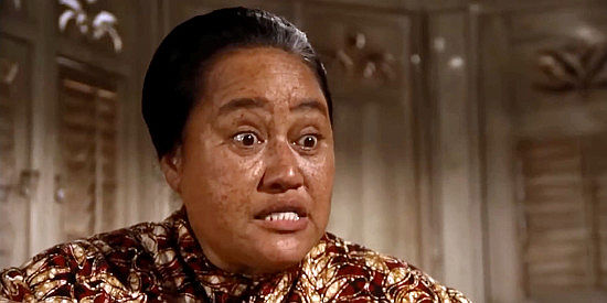 Elizabeth Smith as Liliha, trying to get Costain used to Hawaiian cuisine in The Castaway Cowboy (1974)