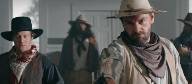 Chris Routhe as Harrison Griggs, about to kill a preacher in Bad Men Must Bleed (2025)