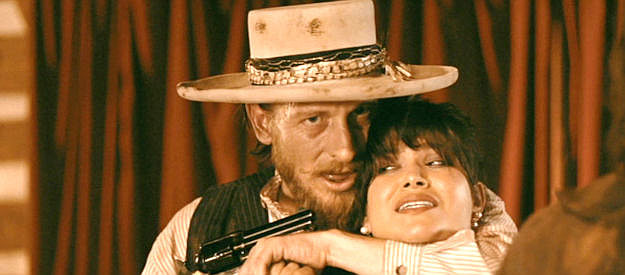James Landry Hebert as Cook with Sophia (Alyssa Wapanatahk) under his gun in Cottonmouth (2025)