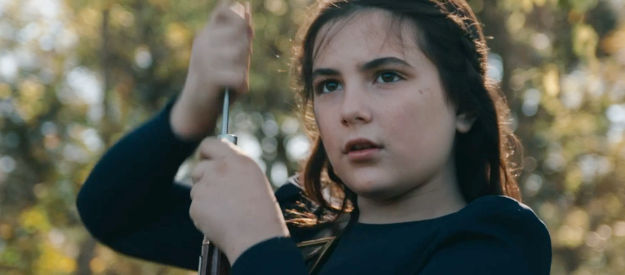 Lexi Rabe as Emma, loading her gun to defend her friends in Bad Men Must Bleed (2025)