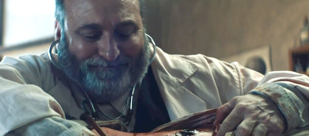 Tony Eckstat as the Army surgeon, inspecting Israel Terry's wound in The War Between (2025)