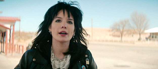 Halsey as Mandy Starr, feeling from one abusive man to another with a fortune in her car trunk in Americana (2023)
