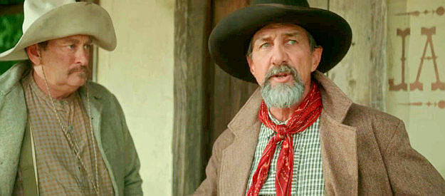 John Marrs as Print Olive, determined to find the killers and asking hired hand Sam (Cliff Owens) to spread the word in Killin' Jim Kelly (2025)