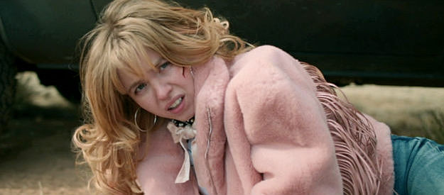 Sydney Sweeney as Penny Jo, treated roughly by members of the Red Thunder Society in Americana (2023)