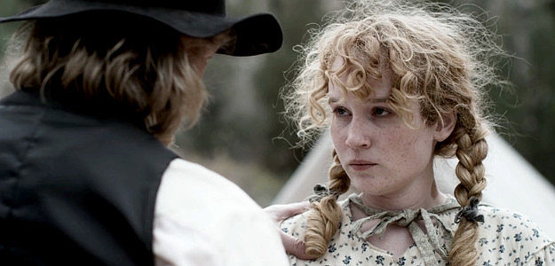 Zipprah Cardozo as Sarah Ballard, given the job of watching over the younger children if bandits attack in This Bloody Country (2025)