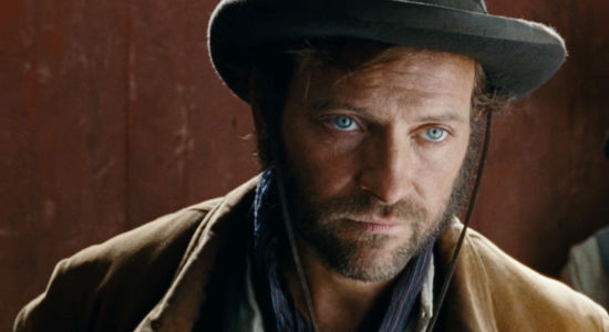 Alessandro Borghi as Santino, getting his orders from Ercole Rupe in Heads or Tails (2025)