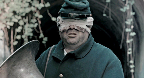 Alex Watson as Emmit, a Union bandsman blinded at The Wilderness but still protective of his instrument named Beatrice in Marbles and Bullets (2025)