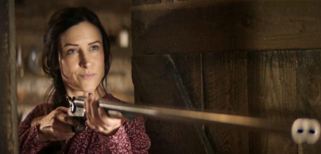 Ashley Elaine as Jessie Strong, greeting Chase Logan with a shotgun in Where the Wind Blows (2025)
