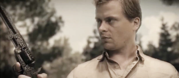 Drew Hirschboeck as Jack Wyatt, marveling over the power of a special six-gun in Jack Wyatt and the Gun from Hell (2021)