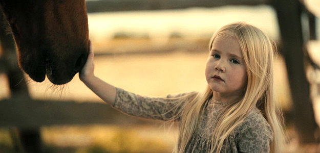 Emily Ford as the Girl, taking off her glove to pet a horse in Killing Faith (2025)