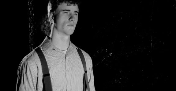 Gunnar Dalton as Henry 'Duck' Mallard, encountering a strange sight in the forest in Buried on Shine Mountain (2024)