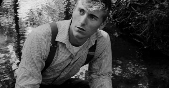 Gunnar Dalton as Henry 'Duck' Mallard, facing accusations from Curt Carter in Buried on Shine Mountain (2024)