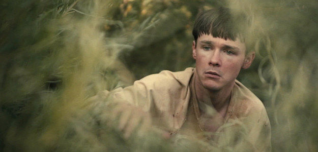 Jack Alcott as Edward, the simple-minded farmhand Sarah has taken under her wing in Killing Faith (2025)