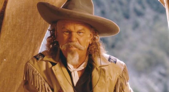John C. Reilly as Buffalo Bill, sharing his own brand of frontier wisdom in Heads or Tails (2025)