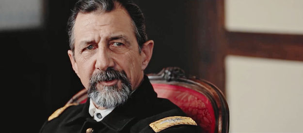 John Marrs as Col. Burnside, wondering if the report on Rhodes' mission was written by someone who's crazy in Blood Totem (2026)
