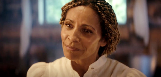 Michelle Hurd as Mrs. Hollyhock, the good friend who frets about Jessie's reputation in Where the Wind Blows (2025)