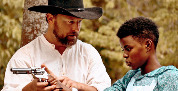 Don Jeanes as Sam giving teenage Reina (Ellen Harris) six-gun lessons in Reina of the West (2022)
