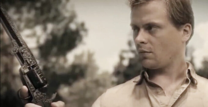 Drew Hirschboeck as Jack Wyatt, marveling over the power of a special six-gun in Jack Wyatt and the Gun from Hell (2021)