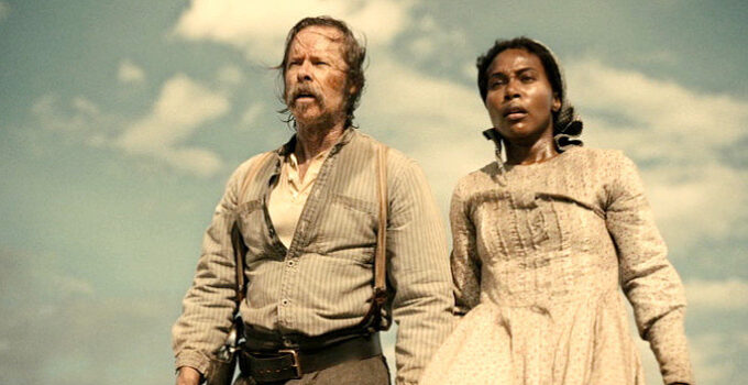 Guy Pearce as Doc Bender and DeWanda Wise as Sarah stumbling upon a tragic scene in Killing Faith (2025)