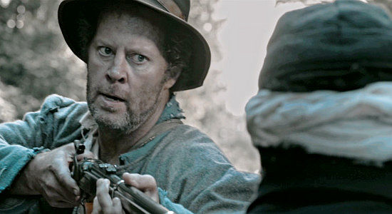 Shuler Hensley as Samuel Barnett threatens a wounded Union soldier at gunpoint in Marbles and Bullets (2025)