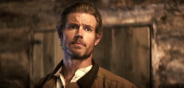 Trevor Donovan as Chase Logan, breaking the news of Nathan Strong's death to his widow in Where the Wind Blows (2025)
