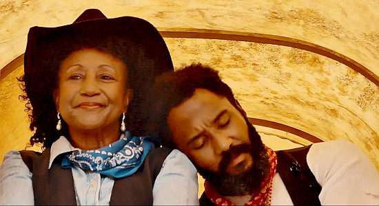 Trish D. Powell as Reina, not minding having Wayne Wesley's (John Aston's) head on her shoulder one little bit in Reina of the West (2022)