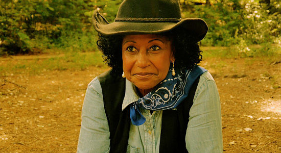 Trish D. Powell as adult Reina, turned bounty hunter to save her ranch in Reina of the West (2022)