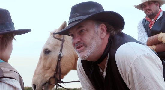 Michael Malone as Johnny McCall, putting a fright into a young boy in The Whore and the Horseman (2025)